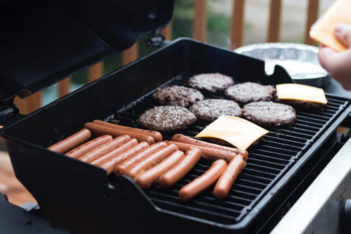 Image of grilling safety precautions, including tools, clothing, and fire safety measures