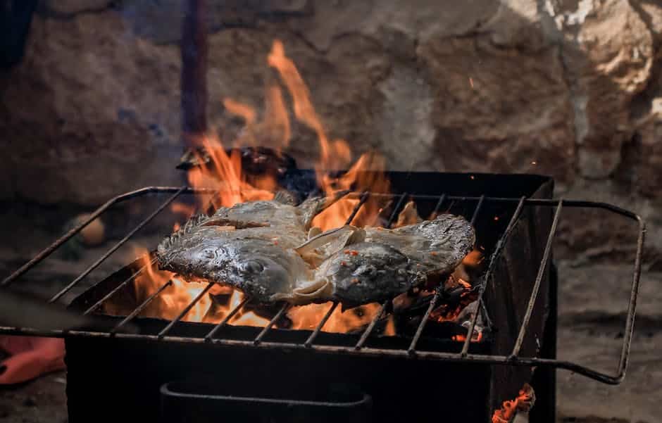 An image of a perfectly grilled fish with charred grill marks and garnished with fresh herbs and lemon slices.