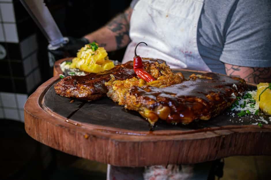 Image description: A mouth-watering image of smoked brisket and ribs on a grill, showcasing the treasures of indirect grilling.