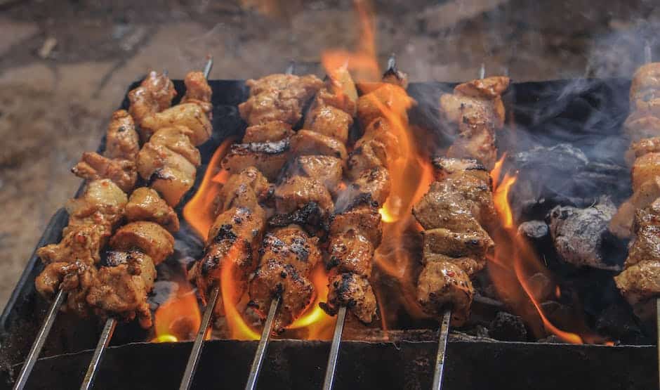 A picture of a wood-fired grill with smoke billowing out, perfect for adding a smoky flavor to grilled food