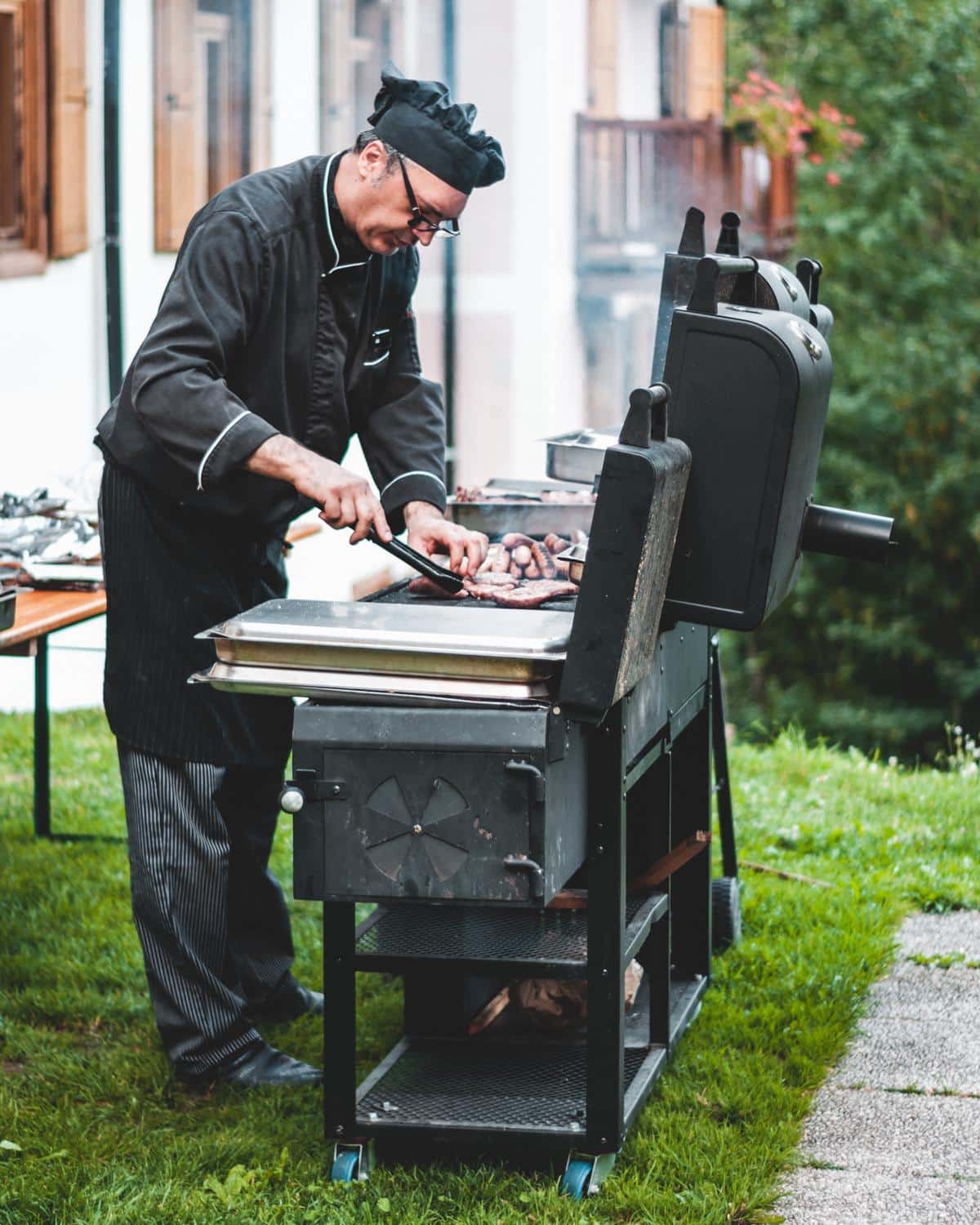 Image depicting a chef grilling with indirect heat on a barbecue