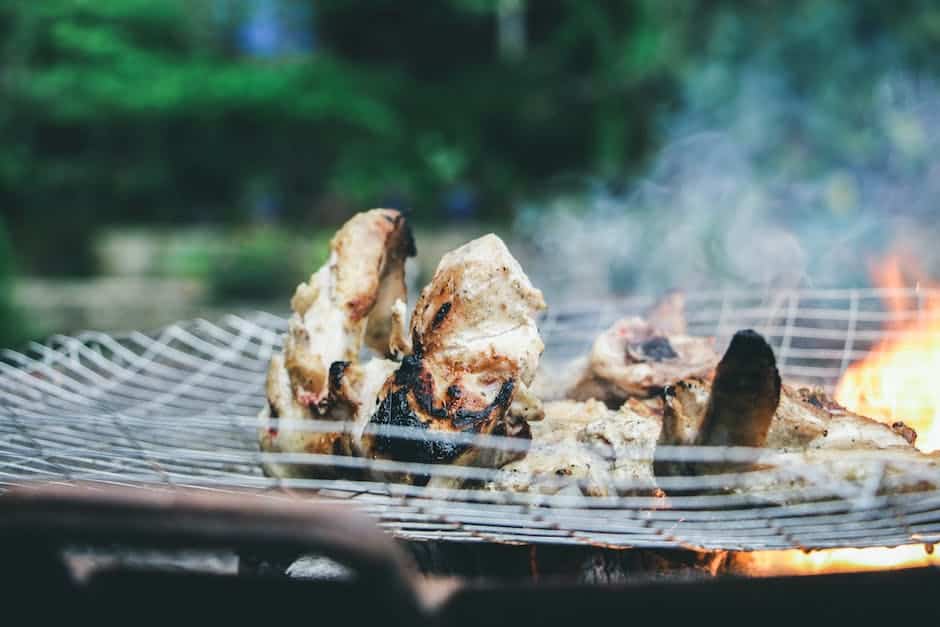 A picture of a Kamado grill with charcoal and flames, showing the grill in action.